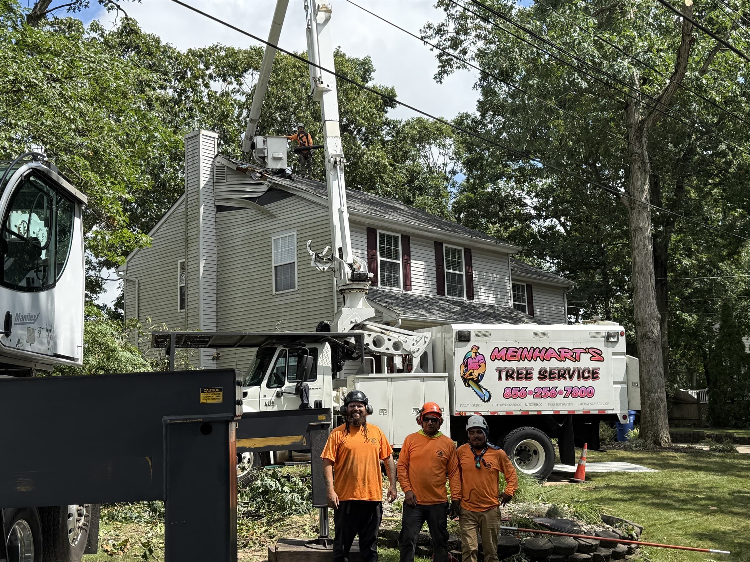 Meinhart's Tree Service crew after safely removing the fallen oak from a Mantua Township home